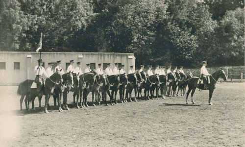 VMI Cavalry Troop A at the VMI stables, late summer or early fall, 1945. Troop commander Cadet James M. Morgan (Class of 1945) is in front; Charles J. Schaefer (1948B) is third from left.