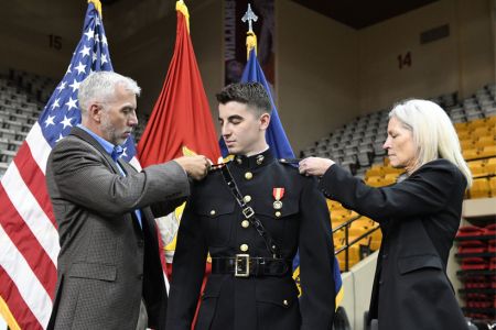 VMI graduating cadet receives rank insignia for the US Marine Corps during pin-on and commissioning events after completing the Marine ROTC requirements.