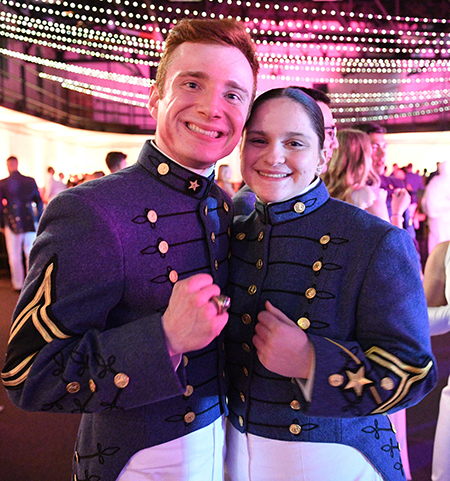 Cadets pose with their rings at a dance.