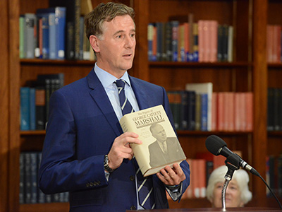 Rob Havers holding Vol. 7 of the Marshall papers