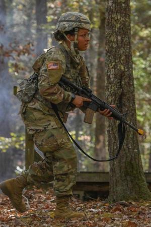 Cadet walks through woods during FTX