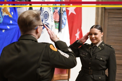 A female graduate salutes CSM Rubenstein during Army Commissioning at Virginia Military Institute.