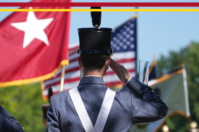 A VMI cadet salutes the flag during a parade.