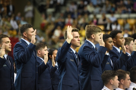 Air Force ROTC cadets raise hands and take their oaths during commissioning ceremony where they will become Second Lieutenants.