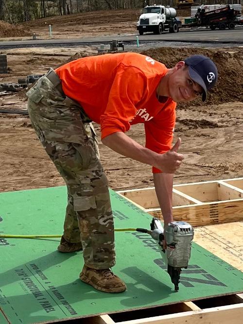 VMI cadet works with a nail gun during a service project.