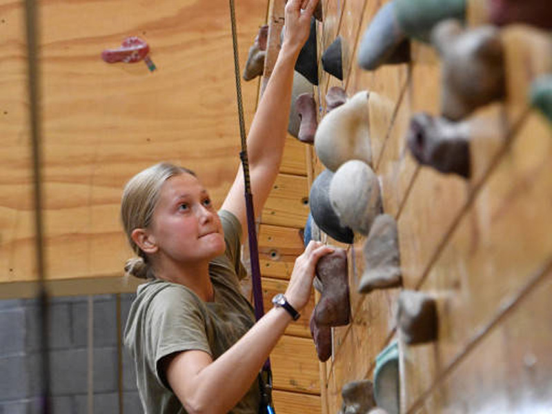 First year VMI cadet ascending rock climbing wall during Rat Olympics