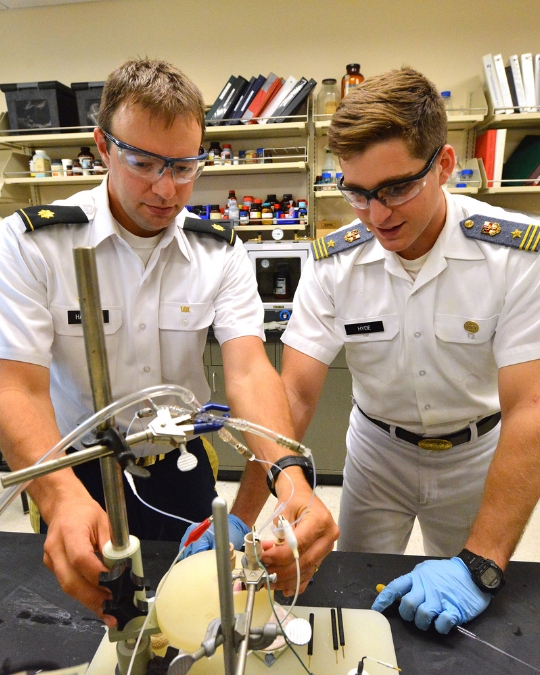 Lt. Col. Daniel P. Harrison ’05, Ph.D., VMI chemistry professor, works with a student, known as a cadet at VMI, in a chemistry lab.