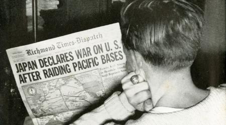 VMI cadet reads the Richmond Times Dispatch front page regarding Japanese declaration of war.