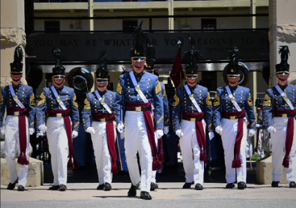 Photo of cadets marching in line in full uniform. 