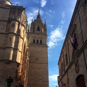 Photo of the Cathedral de Salamanca in Spain, taken by Cadet Emma Pratt on a study abroad trip. The cathedral is show from an angle below the tower, with a clock visible