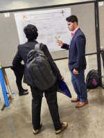 Cadet Hale shares his research with a conference attendee.