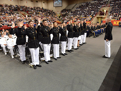 Cadets entering the U.S. Marine Corps stand to take the oath.