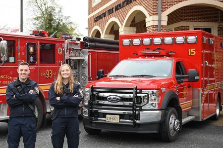 Cadet EMTs pose in front of a firetruck and ambulance at Lexington Fire Department.—VMI Photo by Eric Moore.