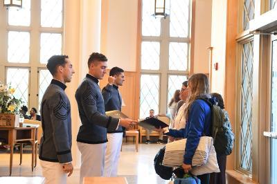 William Wallace ’22, Dane Hamilton ’22, and Kelly Rollison ’22 greet prospective cadets and their families in Lejeune Hall during Open House Oct. 15.—VMI Photo by Kelly Nye.