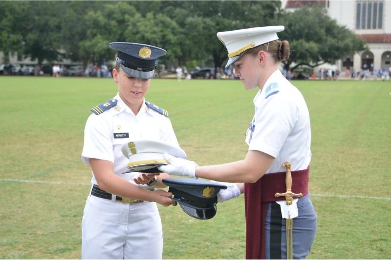 Kasey Meredith ’22 and Kathryn Christmas, Citadel regimental commander, exchange momento covers at the Citadel.—VMI Photo by Eric Moore.