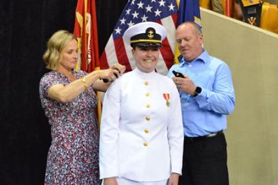 Cadet receives her shoulder boards during ceremony for Navy in Memorial Hall May 15 2022