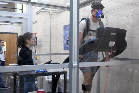Beverley Buchanan ’23 monitors data outside hypoxic chamber as Abaigeal Doody ’23 observes male subject inside the chamber, during their research on stress at VMI. -VMI Photo by Marianne Hause.
