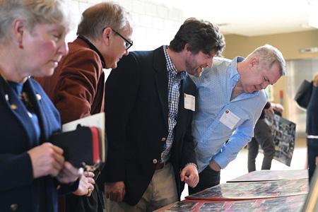 VMI Theatre alumni enjoy photos from productions over the years on April 30 in Marshall Hall.—VMI Photo by H. Lockwood McLaughlin.