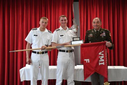 Col. Adrian T. Bogart III ’81, commandant of the Corps of Cadets presents the Commandant Cup to Company F.
