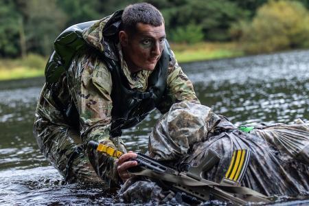 Cody McGuire ’25 exits the reservoir at the water crossing stand at Exercise Cambrian Patrol on October 8, 2024, in Wales.