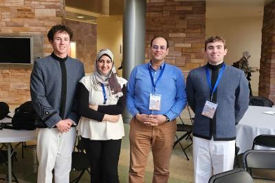 Sean Harvey ’27, Efat Fathalla, Ph.D., Mohamed Azab, Ph.D., and Michael Jorgensen ’27 pause before presenting their paper at the 15th Annual IEEE Computing and Communication Workshop and Conference at the University of Nevada, Las Vegas.