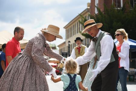 A young guest at Apple Day joins the Shenandoah Valley Civil War Era Dancers in a period dance.