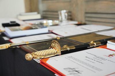 Award certificates, swords, and other prizes await the recipients during a ceremony at VMI.