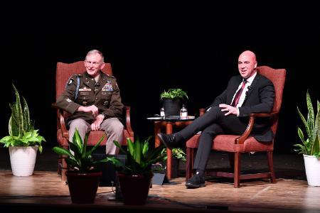 Col. David Gray and Benjamin Anthony listen on the stage in Gillis Theater as a cadet in the audience asks a question.