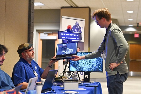 A student checks in on progress on his laptop.