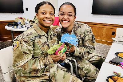 Students (cadets) at VMI, a military college, design crafts during a Global Festivities event on campus (post).