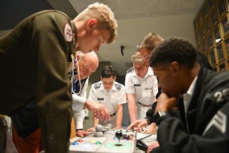 A team works together to progress through the game challenges of SynergyK, during the conference in Marshall Hall