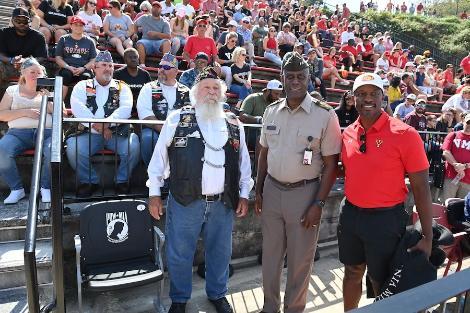 Vietnam veteran Jimmy Eubanks, Maj. Gen. Cedric T. Wins ’85 and Jamaal Walton ’07 unveil the POW/MIA Chair of Honor in Foster Stadium Sept. 21.