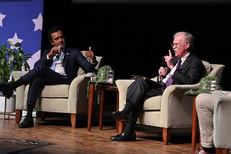 Vivek Ramaswamy and John Bolton speak from the stage at VMI's Gillis Theater.