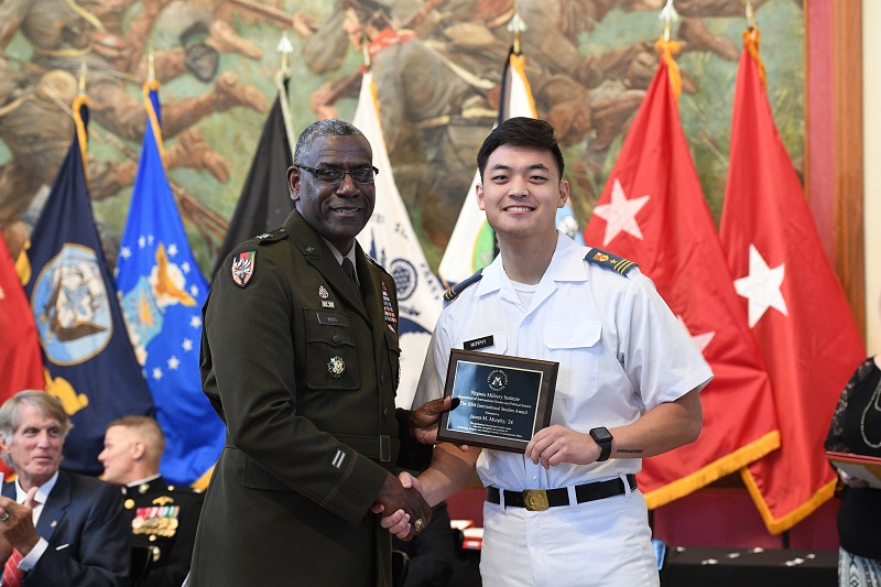 A senior at VMI receives an academic award from the military college superintendent during Graduation Week activities.