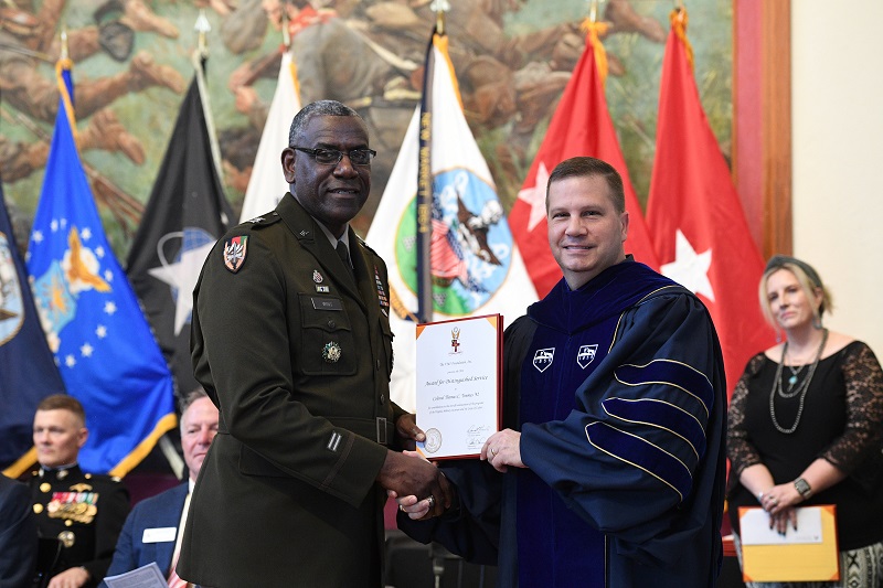 VMI superintendent Maj. Gen. Cedric T. Wins, Class of 1985 alumnus, presents a faculty member, Col. Tom Timmes, with a certificate during the Institute Awards ceremony at VMI.