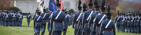 The VMI Corps of Cadets marches, in uniform, during a parade.