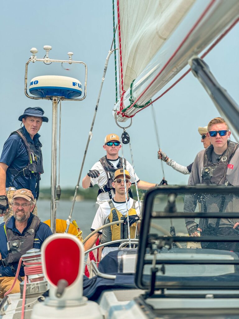 Crew members on sailboat.