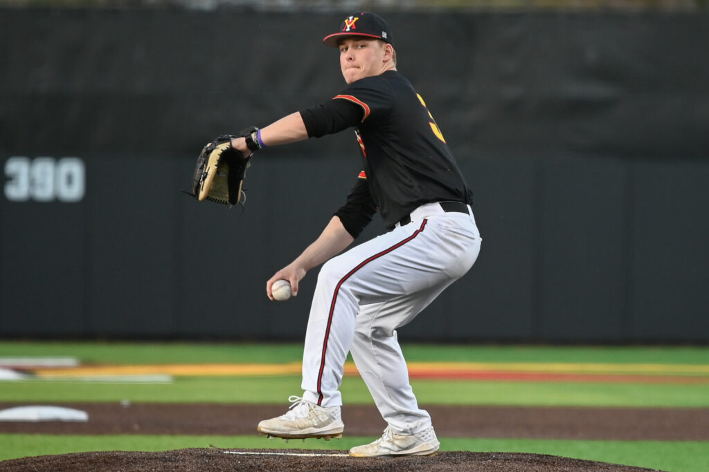 Caden Plummer throwing a baseball during a Virginia Military game.