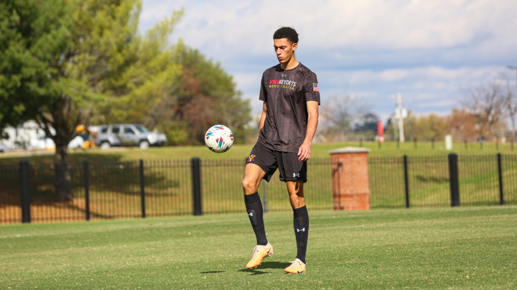 Conner Reid on the soccer field with a ball, playing for Virginia Military Institute. 