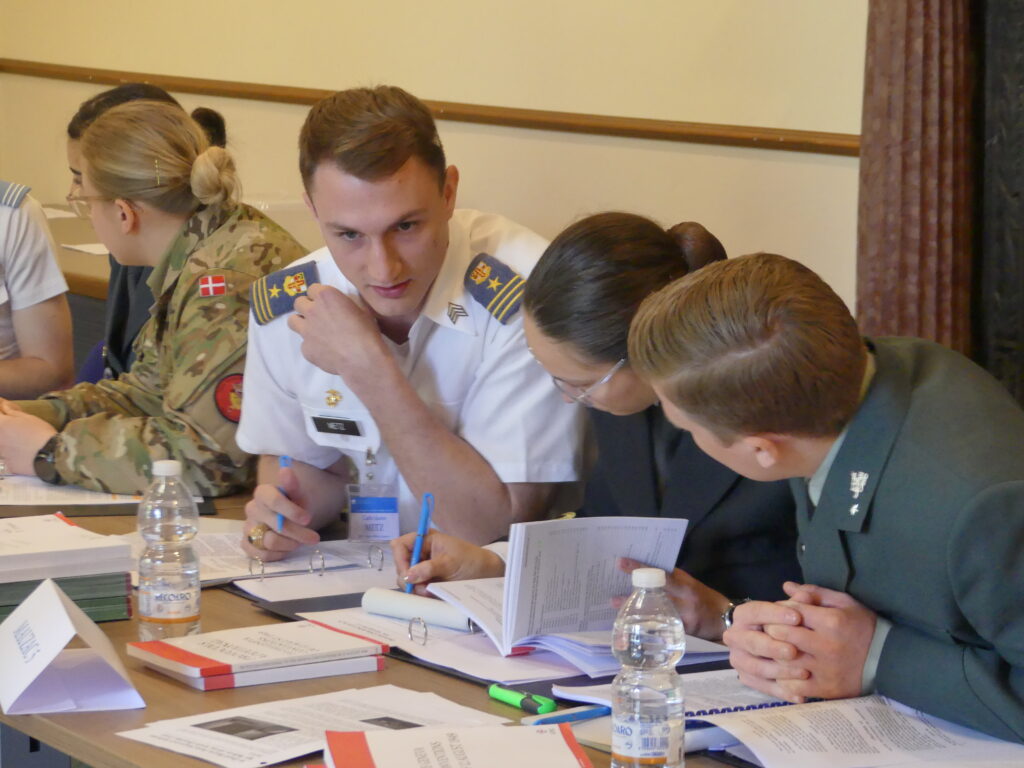A cadet speaks with others during a competition. 