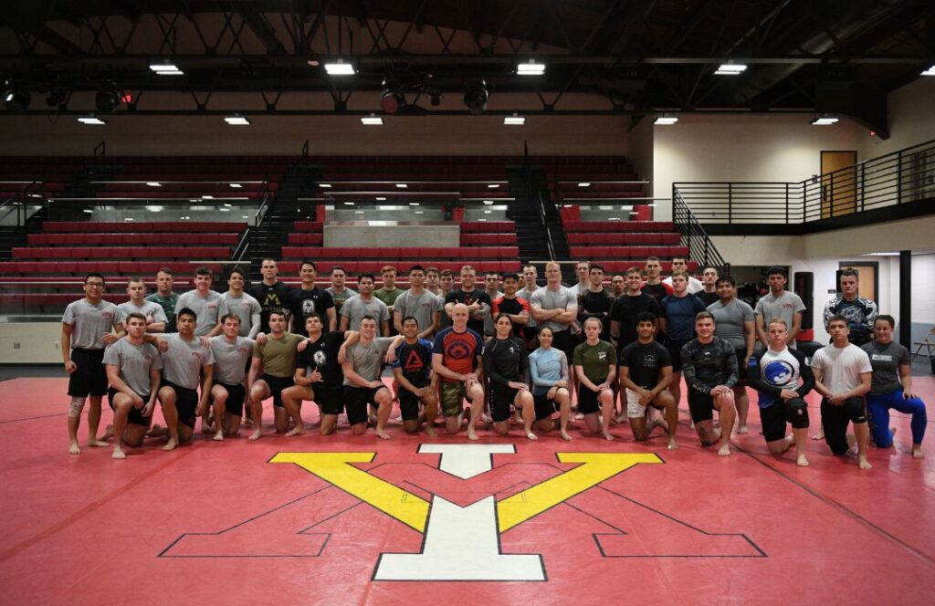 The Brazilian Jiu-Jitsu Club at VMI pose for a picture on the mat.