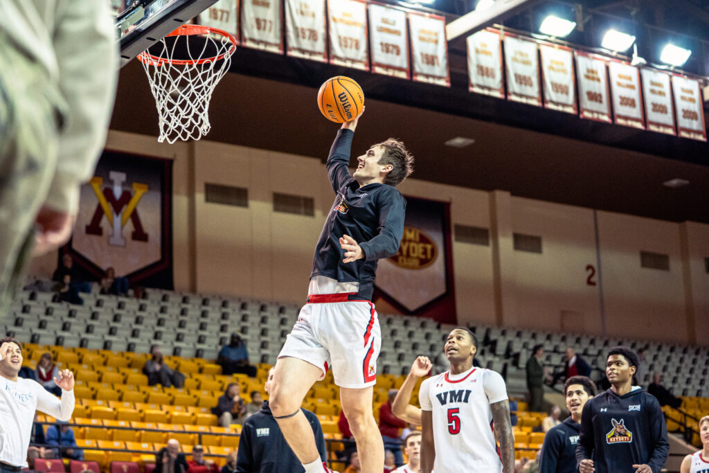 TJ Johnson dunking a basketball during a game for Virginia Military Institute.