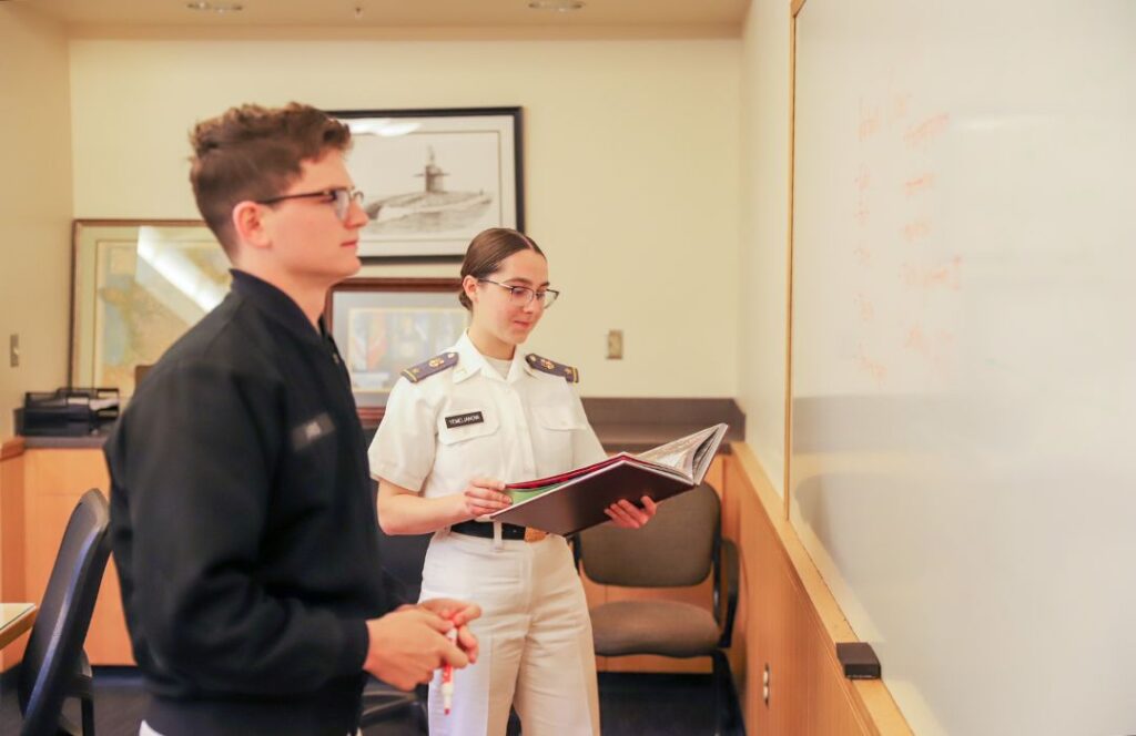 Two students plan out portions of the VMI yearbook, "The Bomb."