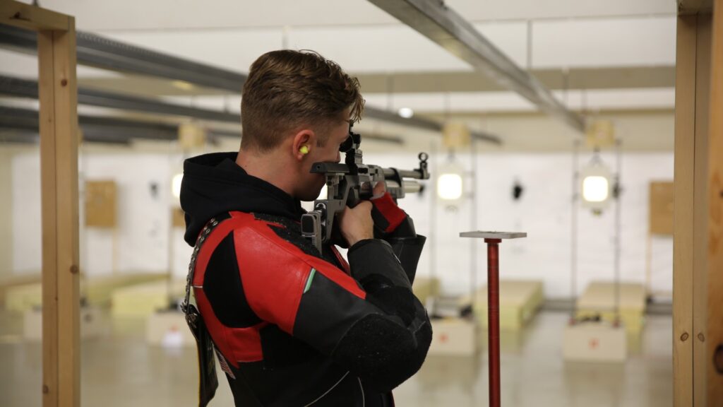 Christopher Hicks shooting a rifle for Virginia Military Institute's rifle tea\m.