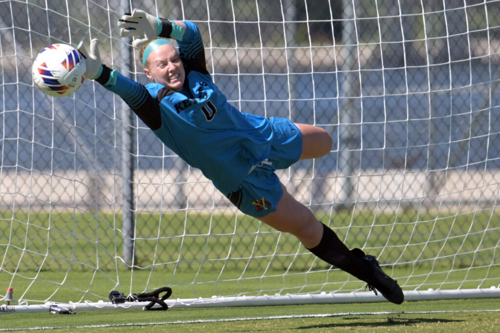Whitney Tracy blocking a soccer ball during a Virginia Military Institute women's soccer game.