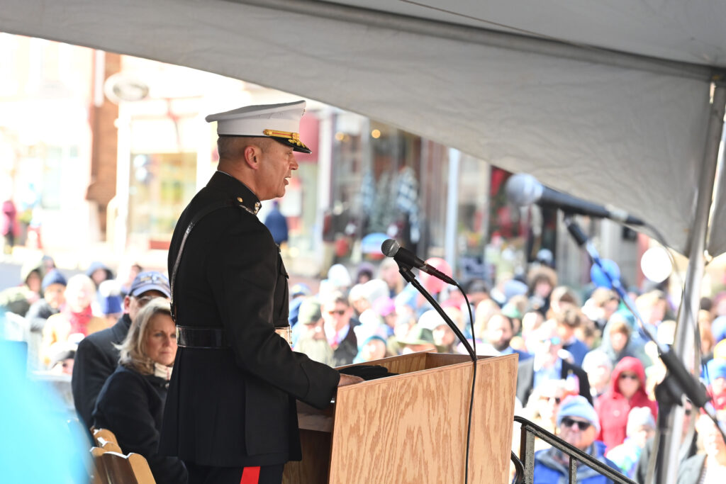 Furness stands at a podium.