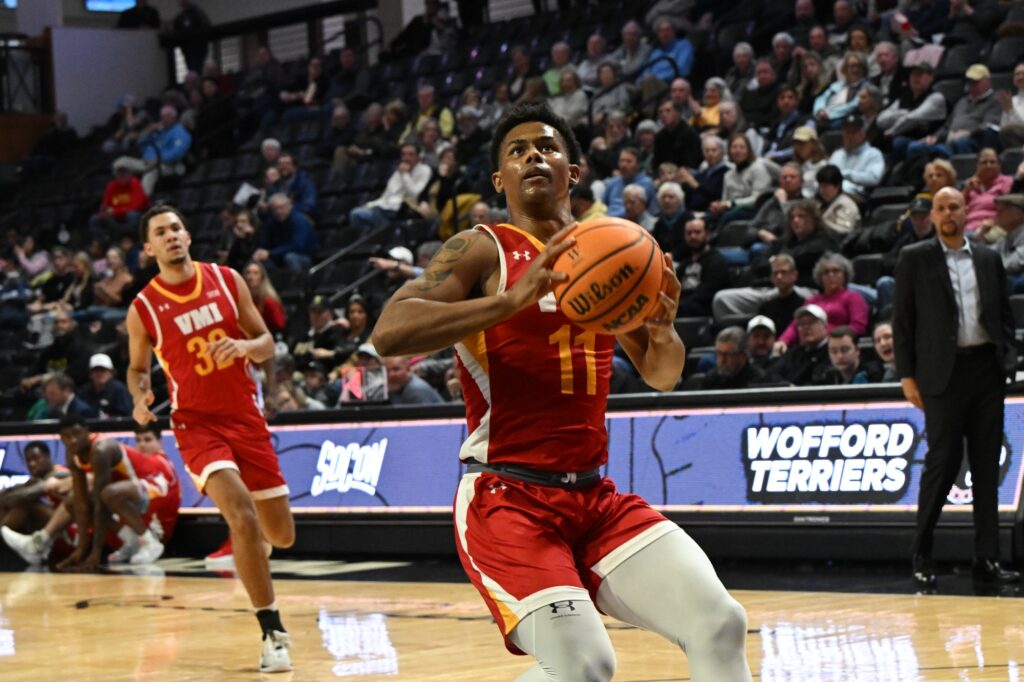 Devin Butler about to shoot a basketball during a Virginia Military Institute men's basketball game.