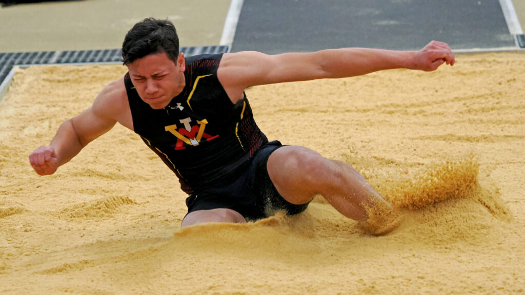 Zach Denton jumping at a track and field meet at Virginia Military Institute. 