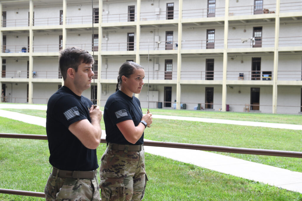 Cadets practice saber work in barracks.