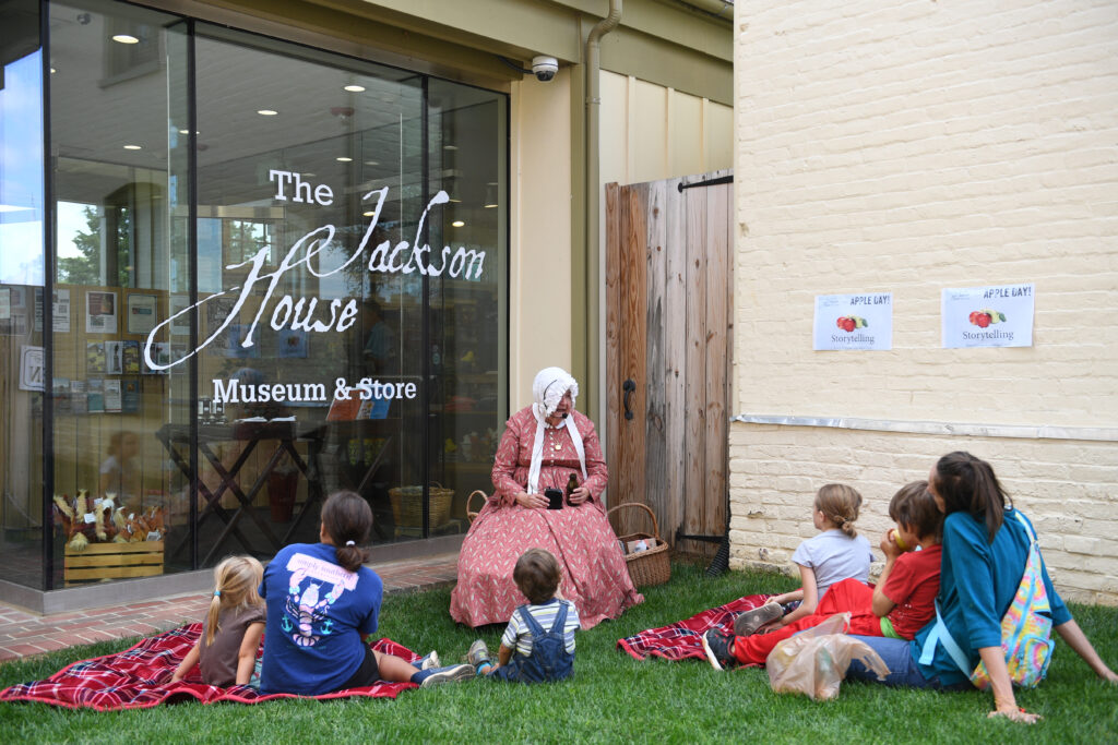 A museum intepreter works with young visitors